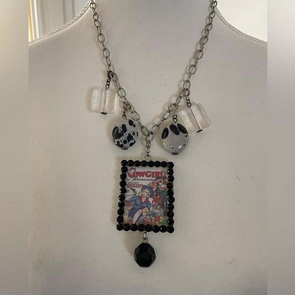 Women’s silver tone necklace with reversible pendant.